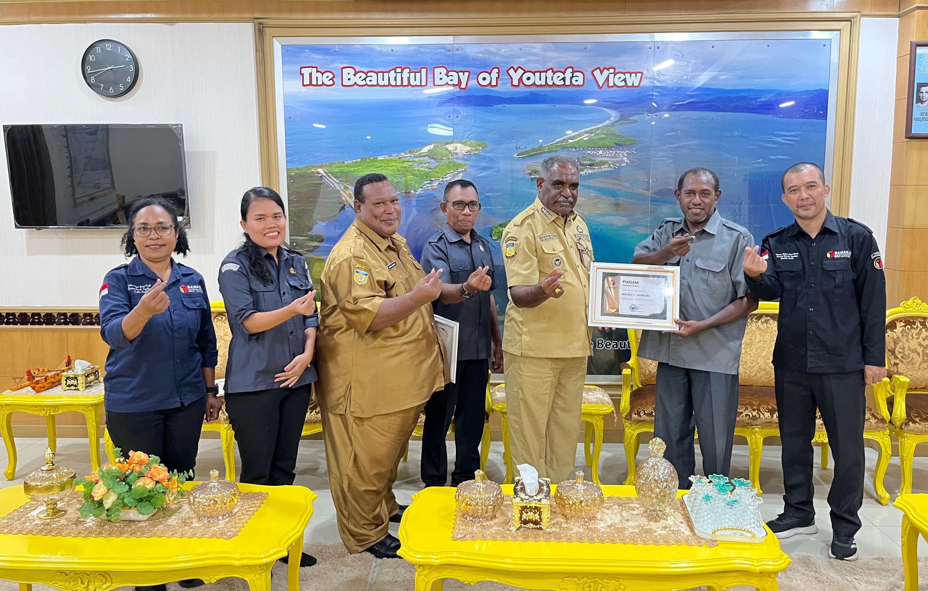 Foto bersama penyerahan cendramata oleh Bawaslu Kota Jayapura kepada Walikota Jayapura atas dukungan aktif dalam menyukseskan Pemilihan Umum Tahun 2024 dan Pemilihan Kepala Daerah Tahun 2024 I Foto diambil oleh Humas Bawaslu Kota Jayapura